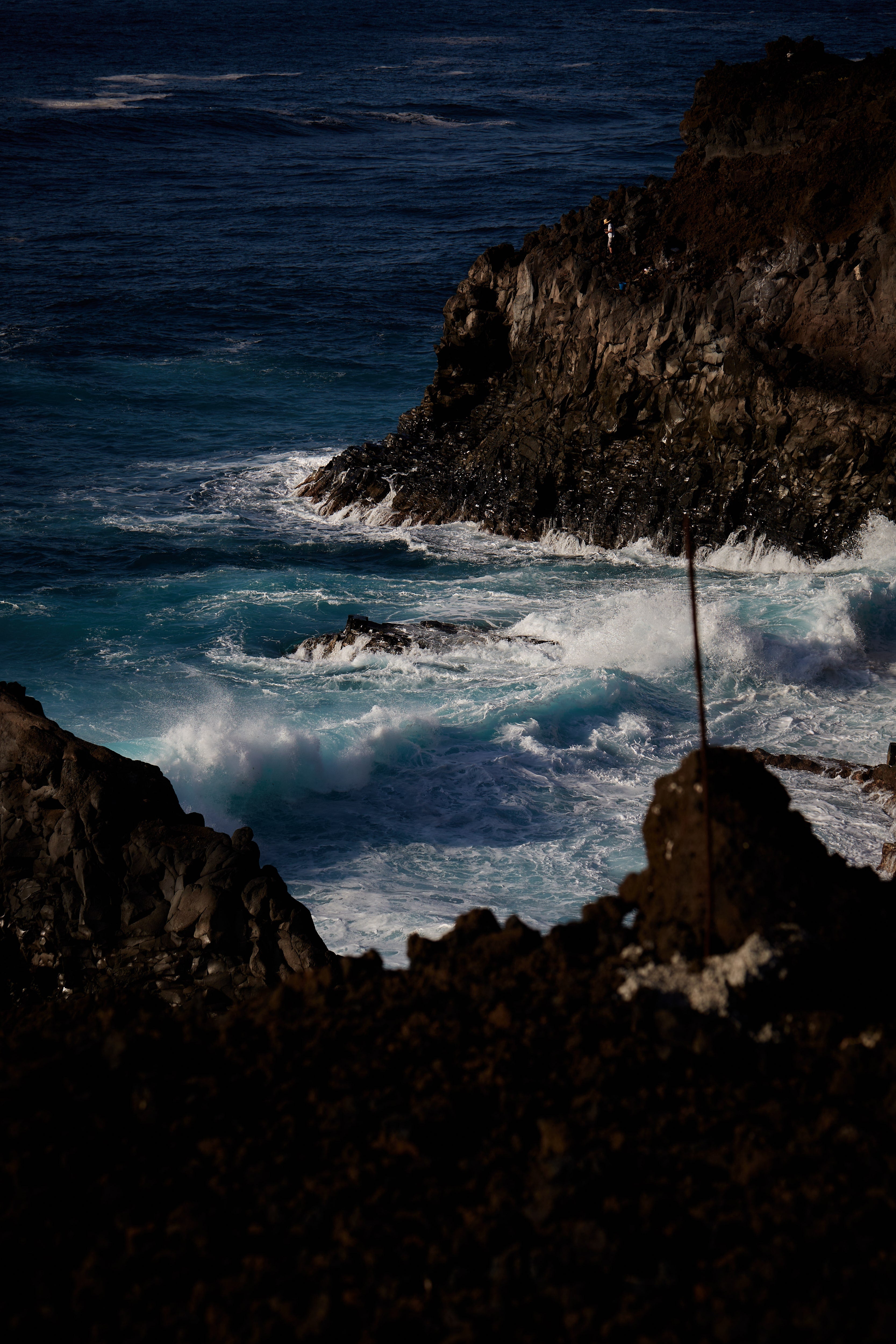 FISHERMAN ON THE ROCK